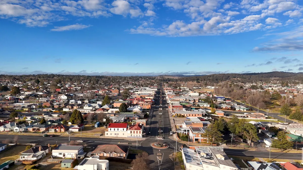 Aerial view of a regional Australian town and countryside under blue sky