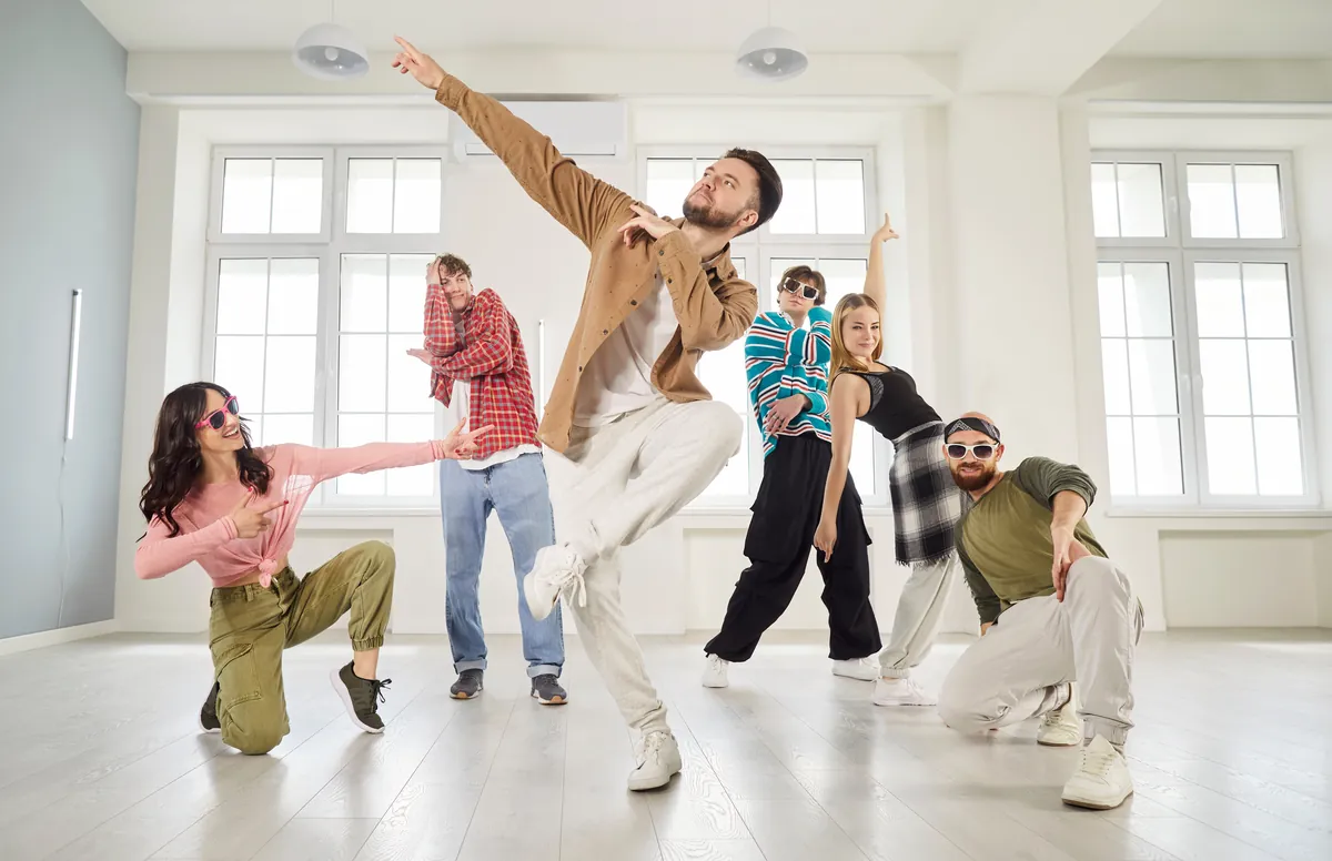 Dancers rehearsing together in a bright studio